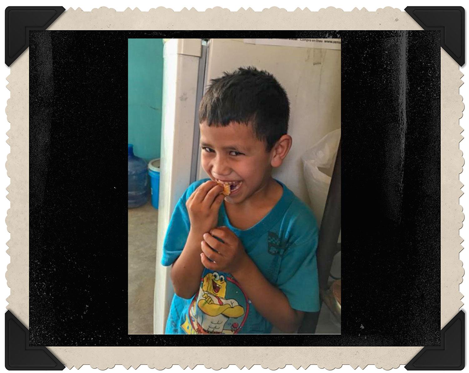 boy eating a croissant